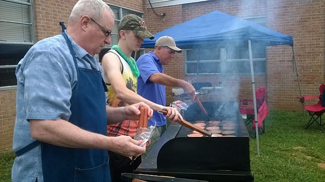 Senior Chief Maness leads the grilling effort with Cadet Lippmann and Captain Adler, the unit’s incoming Senior Naval Science Instructor.
