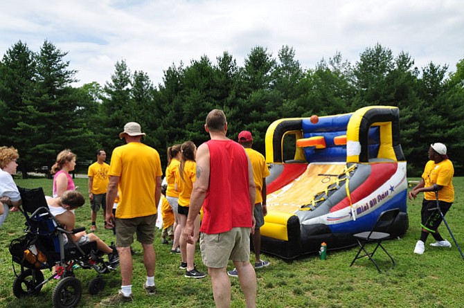 Volunteers teamed up with KEEN athletes for events such as tug-of-war, obstacle course challenges, kick ball, and volleyball on June 7 at Avenel Park. 
