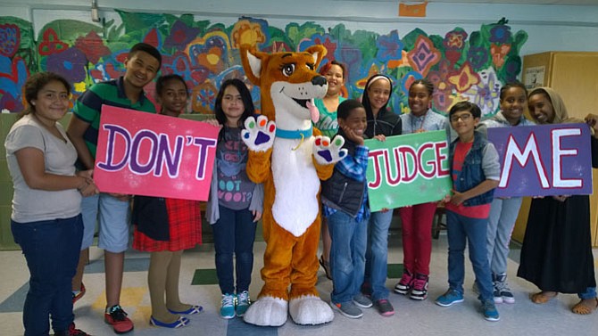 DreamDog Foundation mascot Jazz poses for a photo with Kids Empowering Kids students at the premier of the “Don’t Judge Me” music video June 11 at William Ramsey Elementary School. The students wrote, produced and starred in the video that aims to educate others about tolerance.