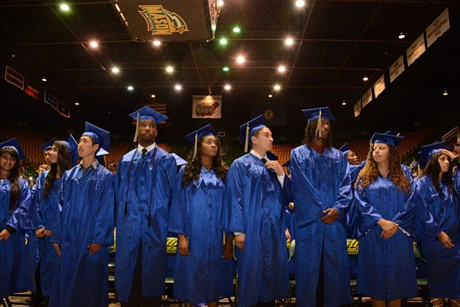 Graduating Lee seniors scan the Patriot Center stands for parents, friends and relatives.