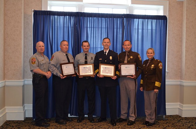Recipients of the Above and Beyond with their awards. From left: Fairfax County Police Chief Roessler, MPO Jason Thompson, PFC Matthew Dannemann,  Northern Virginia Community College Police Chief Daniel Dusseau,  Fairfax County Sheriff’s 2nd Lt. Kevin Timothy and Sheriff Stacey Kincaid. 