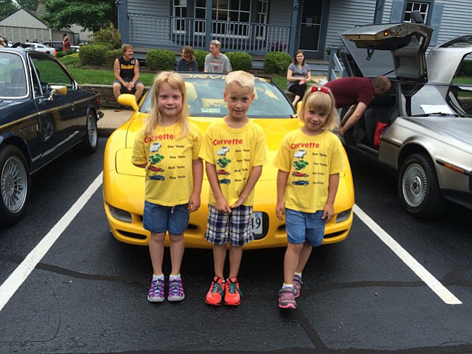 Katie’s Cars and Coffee attendees Anna, Erik and Elaine find the matching car to their shirts at Saturday’s show.
