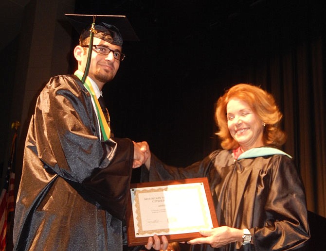 Assim Shammo receives a Citizenship Award from teacher Cathy Collins.
