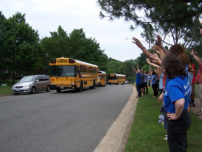 Fort Hunt Elementary School students wave to Fort Hunt staff and faculty as they leave school on the last day before summer vacation.