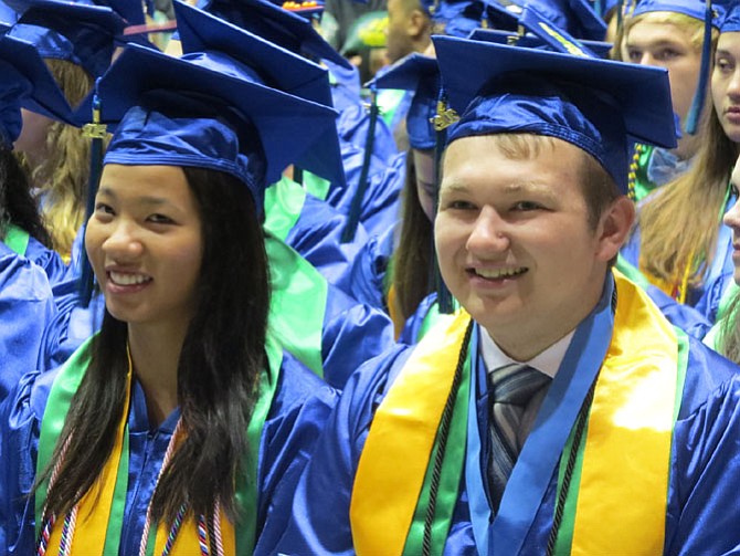 Kimberly Le and Jonathan Lee smile moments after graduating.
