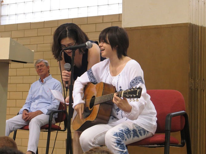 Margaret Gorman (left) and Maryrose Durbin (right, on guitar) sing a farewell song for departing Principal Frank Haltiwanger.