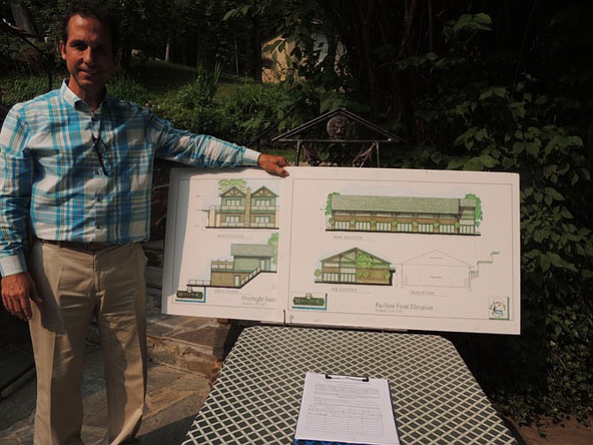 Mark Reges with architectural renderings of the two overnight suites which will provide housing for four couples as well as the wedding pavilion.