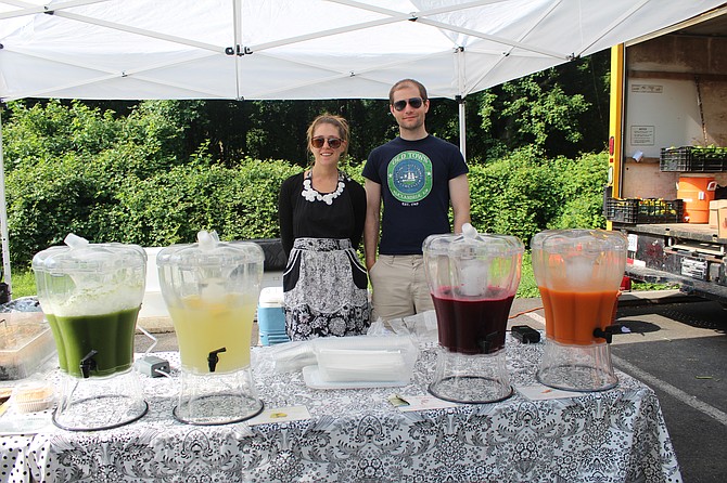 Lisa Marchand of Alexandria and Andrew Burr of Washington D.C. run the juice stand at the McLean Farmers Market on Friday mornings.
