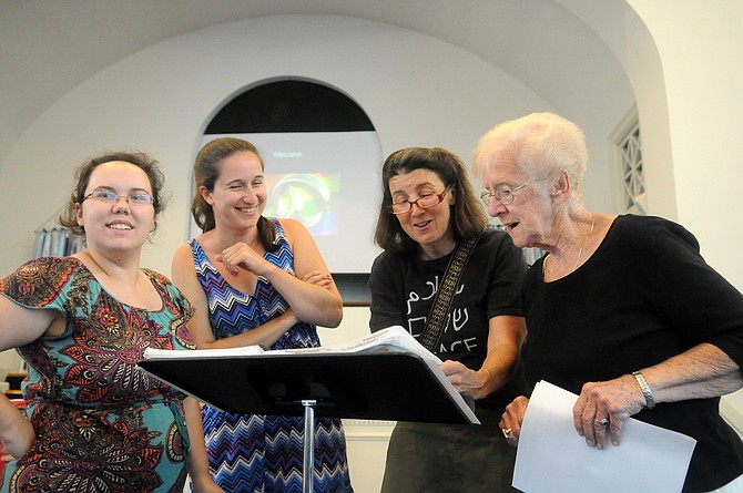 Hannah Meade, Audrey Knox, Dara Baker and Athena Burkett rehearse a few songs before the beginning of the multifaith gathering for marriage equality on Friday evening at Commonwealth Baptist Church.
