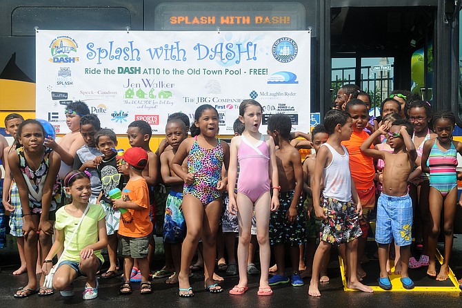 Area children take a break from the Old Town pool to check out the “Splash With Dash” bus that starts service on July 1 on AT10 route.
