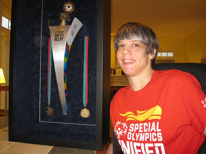 Alexis Guillett of Centreville with her framed Special Olympics Torch and medals.