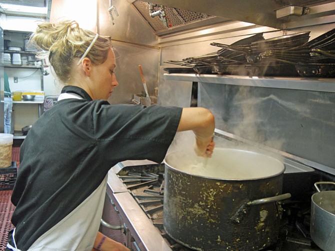 Steam wafts over the stove as Allie Barfield, chef at Bilbo Baggins on Queen Street, stirs the simmering onion soup that she is making for lunch.
