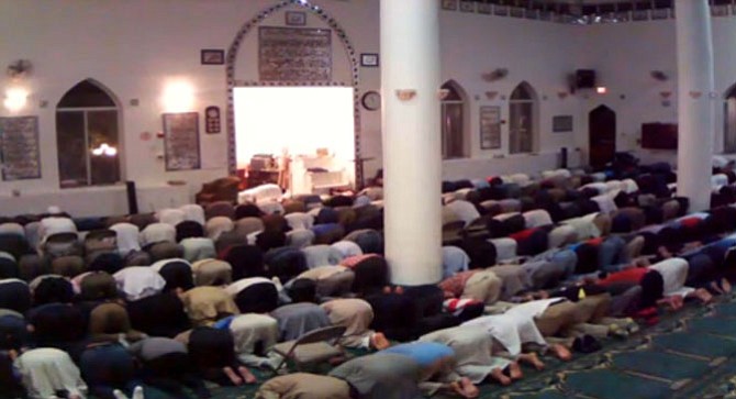 Men at the Islamic Center Northern Virginia Trust bow during the evening’s last prayer Isha’.