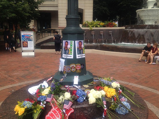 An impromptu memorial for Inspector Carlos Silva was set up by the Mercury Fountain at Reston Town Center. A competitor in the Fairfax 2015 World Police & Fire Games, Silva died in bike crash.
