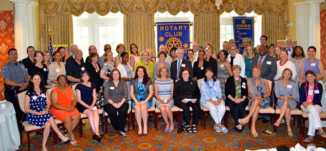 Representatives of 45 local nonprofits gather for a group photo after being presented grants totaling more than $112,000 from the Rotary Club of Alexandria June 30 at Belle Haven Country Club.