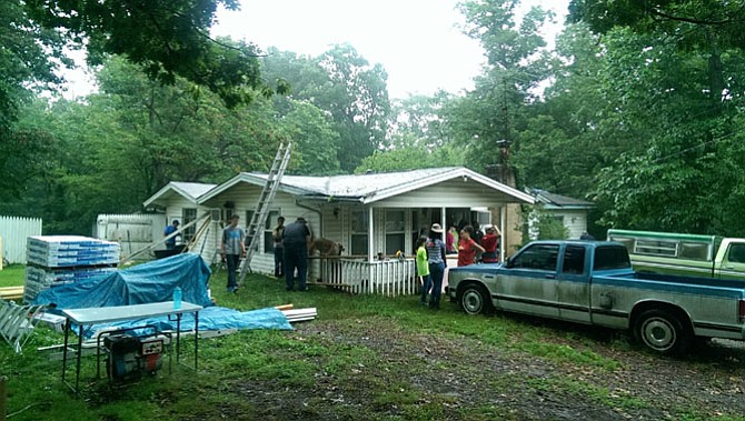 Around 100 youth from all over Virginia are helping repair four houses in Lorton, including yard-clearing, roofing, flooring and other structural work.