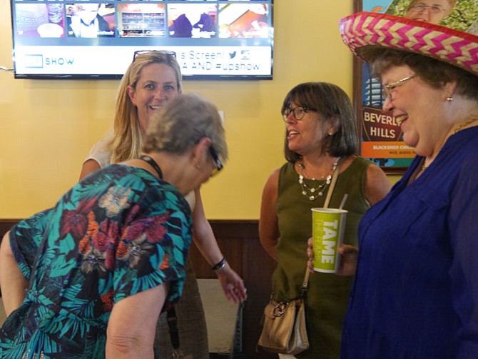 Gail Arnall with her staff and friends share a memory at her retirement party as executive director of OAR.