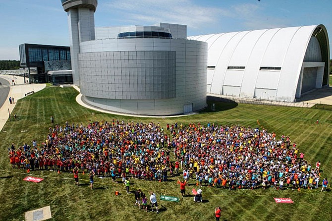 Campers in the Fairfax County Park Authority’s REC-Pac summer program gather to break into the Guinness Book of World Records.