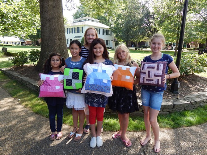 The quilting class with their finished pillows. One side machine quilted and one side hand quilted.
