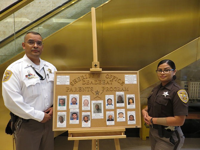 Lt. Richard Laureano and Deputy Daisy Barbadillo with the Deadbeat Parents board.