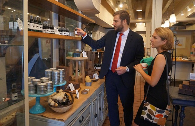 Bill and Alison Rausch browse a selection of handmade bath and body products at Ladyburg, a specialty skin care store now open at 105 S. Union St. in Old Town.
