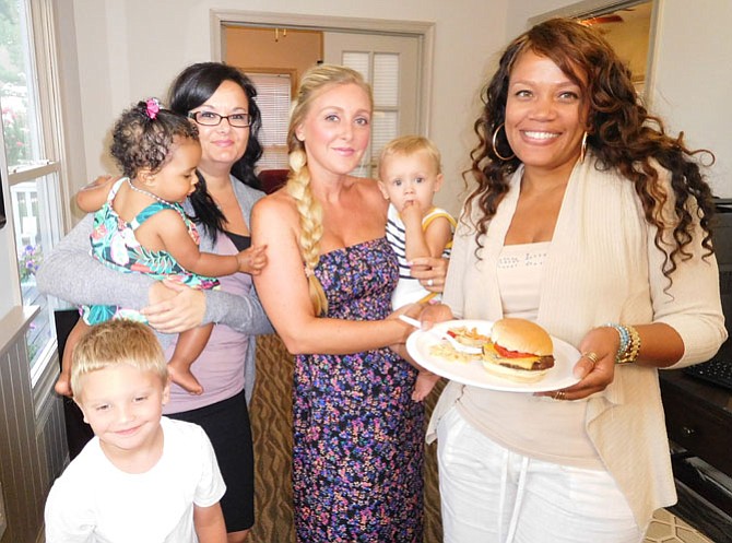 Socializing at The Elms of Centreville are (from left) Amber Boykin and daughter Malia, 1; Jodi Rexrode and son Reece, 1; and Latuana Hicks. In front is Rexrode’s son Landon, 4. 