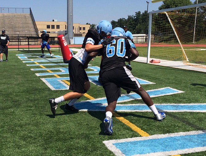 Centreville’s Christian Brooks (60) goes against a teammate during a practice drill.