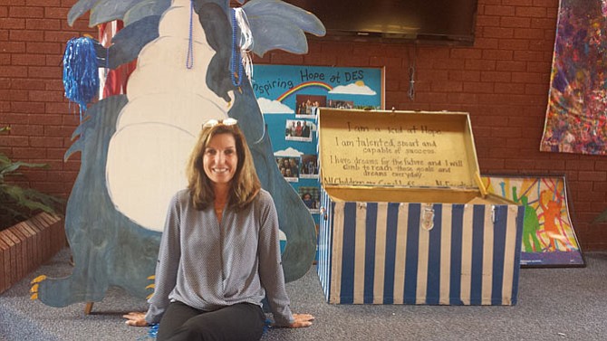 Dranesville Elementary principal Kathryn Manoatl in front of the school mascot and the "Kids at Hope" box.