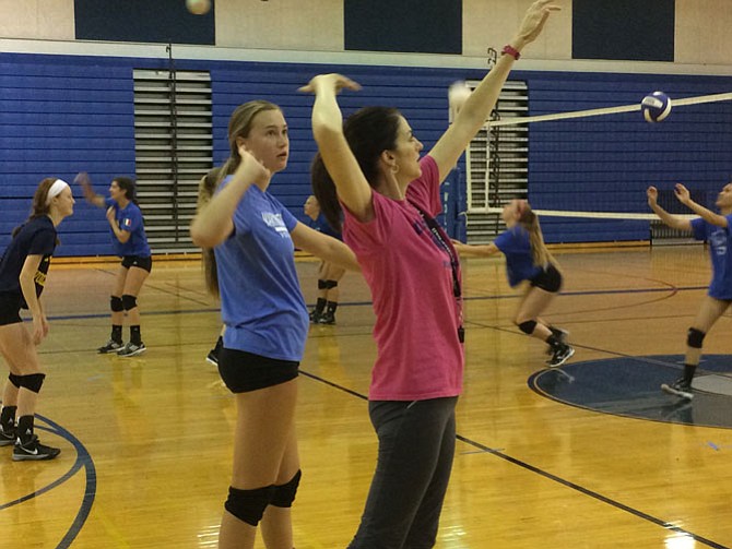 First-year West Potomac volleyball coach Nancy Nixon instructs rising junior middle blocker Laura Aaron during a recent practice.