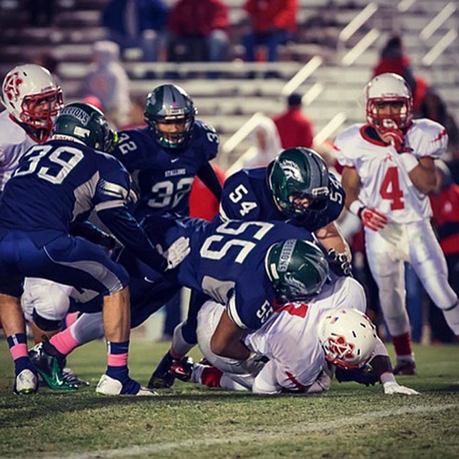 South County’s Saif Khan (55) and Kevin Allen (54) tackle an Annandale player during the 2014 season.