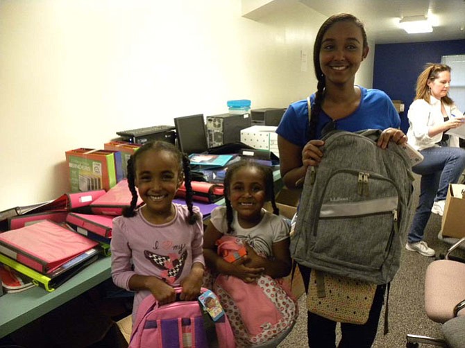 From left, sisters, Nour, 7, Shahd, 5, and Fatima Badawi, 16, get brand new school supplies for the upcoming school year courtesy of FACETS.