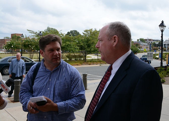 Commonwealth’s Attorney Raymond F. Morrogh (center) speaks with reporters outside the Fairfax County Courthouse following the arraignment hearing for former Fairfax County Police officer Adam Torres. Judge Stephen Shannon denied Torres’ counsel’s request to set a bond; Torres was released to the custody of the Sheriff’s Office. Both parties agreed to begin a jury trial on Dec. 14. 
