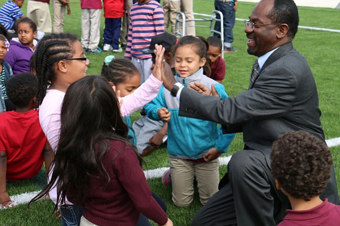 Dr. Alvin L. Crawley, superintendent of schools, talks with students.
