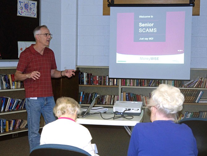 Bill Ross and Mariane Dunne, master financial volunteers for Arlington Financial Extension, teach a class on Senior Scams at Langston-Brown Senior Community Center. 
