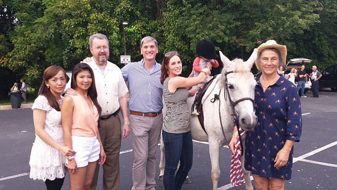 (From left) Hannah Lee and Cindy Huynh, from Great Falls Nails and Spa; president of the Great Falls Business Center Stephen Dulaney; 34th District candidate for delegate, Craig Parisot; Kristin Parisot and owner of The Saddlery, Sarah Kirk.