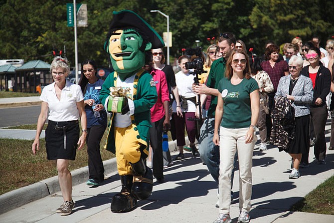 Staff, students and faculty at George Mason University take part in “Who’s Walking Wednesdays,” an effort to increase physical activity and well-being. Research shows that workplace health programs can lead to increased productivity.
