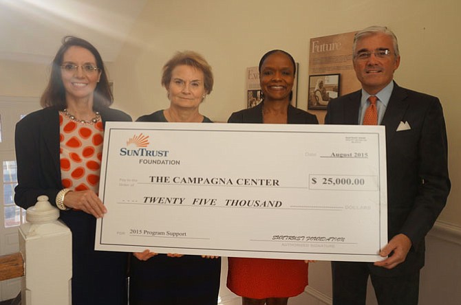 Dan O’Neill (right), president and CEO of SunTrust  Greater Washington/Maryland Division, is joined Aug. 27 by senior vice presidents Mary Anne Martins and Laura Lawler in presenting a check for $25,000 to The Campagna Center CEO Tammy Mann to support the Building Better Futures program for at-risk teens.