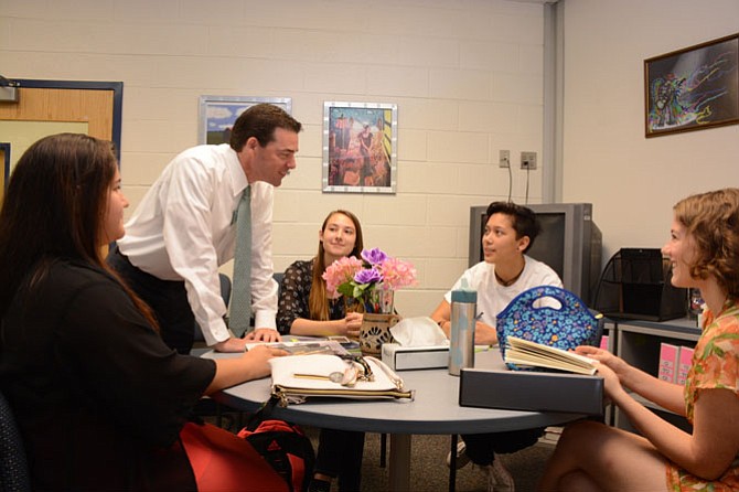 South County High School principal Matt Ragone looks at class schedules with students during the first day of school.