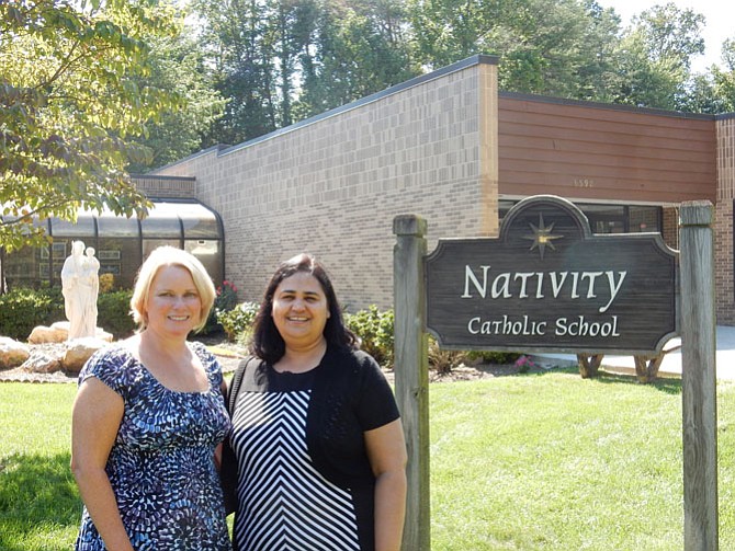 Maria Kelly, principal, and Annie Fernandez, assistant principal, in front of the entrance at Nativity Catholic School. They hope that their technology programs will help the students become “active problem solving learners.”
