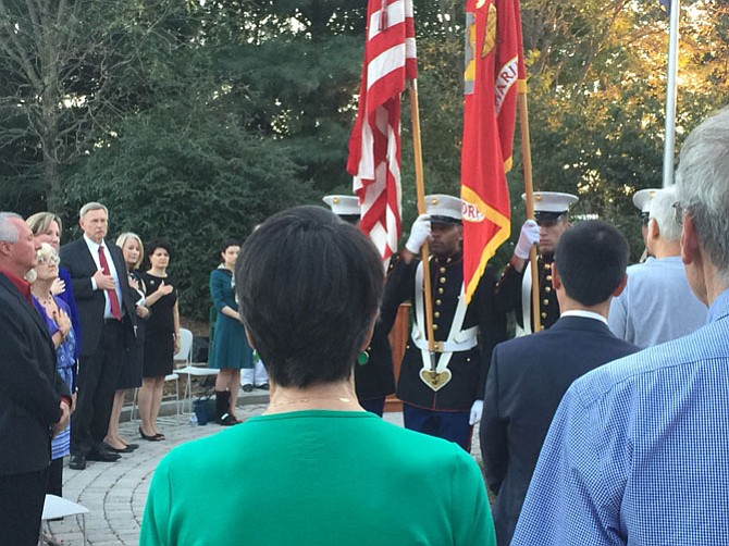 The Color Guard stands at attention while the audience recites The Pledge of Allegiance.
