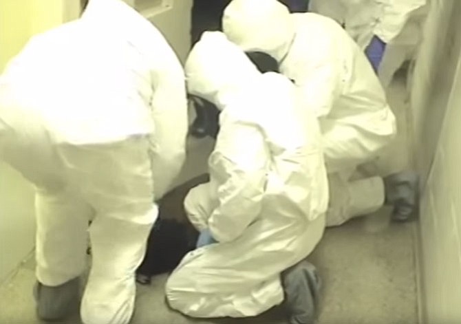 Fairfax County Sheriff’s deputies, wearing protective suits, can be seen forcing Natasha McKenna to the ground outside her cell at the Fairfax County Adult Detention Center in the video released by Sheriff Stacey Kincaid.