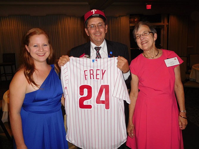 Michael Frey with his Phillies cap and jersey from (from left) labor center Director Molly Maddra-Santiago and CIF President Alice Foltz.
