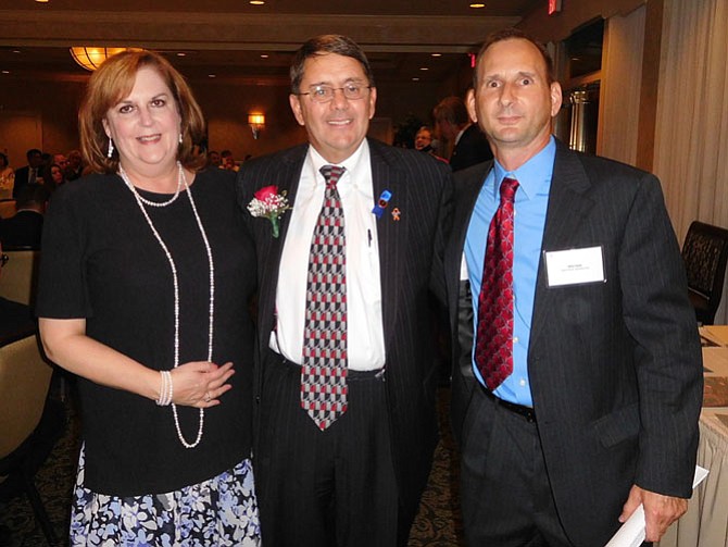 Flanking Supervisor Frey are his staff members Kathy Buckley and Mike Coyle.
