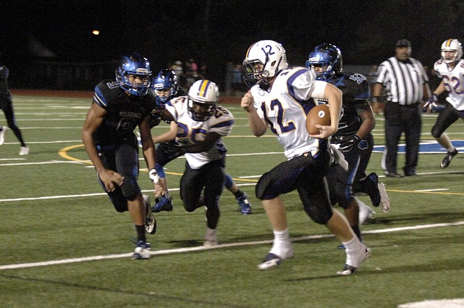 Lake Braddock quarterback Kyle Edwards carries the ball against West Potomac on Friday.