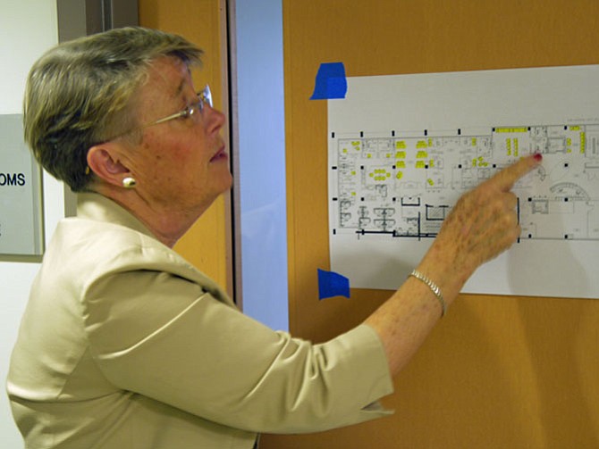 Kathleen Sibert, president/CEO of the Arlington Street People’s Assistance Network (A-SPAN), points to a diagram to the second floor as she moves to the client rooms where homeless can see a therapist or consult with housing counselors: “Our goal is housing. This is a bridge, not an end game.”
