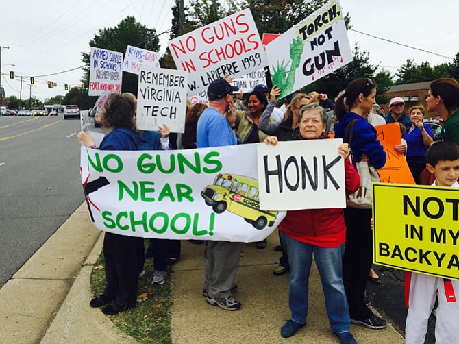 Protesters outside NOVA Firearms in McLean on Saturday, Sept. 26. The gun store is located on property that is adjacent to Franklin Sherman Elementary School.