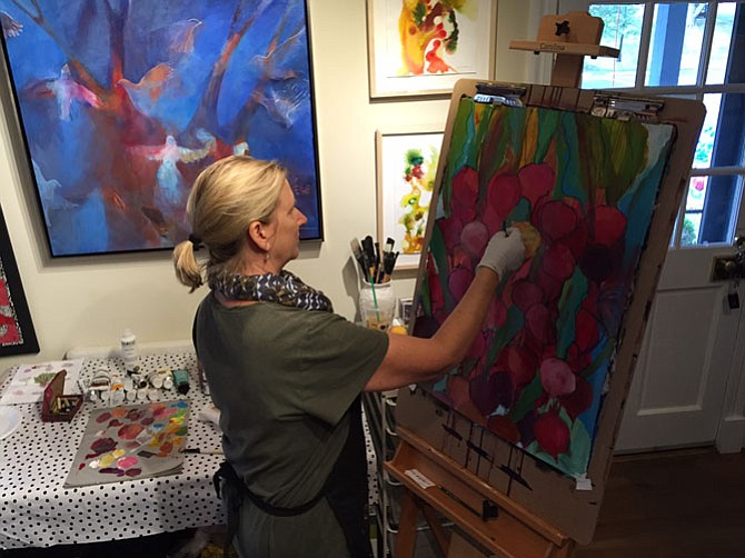 Jennifer Duncan adding charcoal line to mixed-media painting