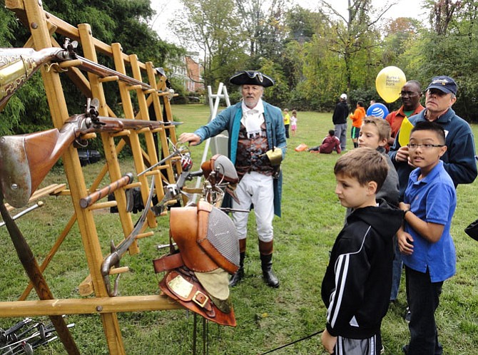 Swordmaster Charles Anderson shows muskets and swords to the crowd at a past Centreville Day.
