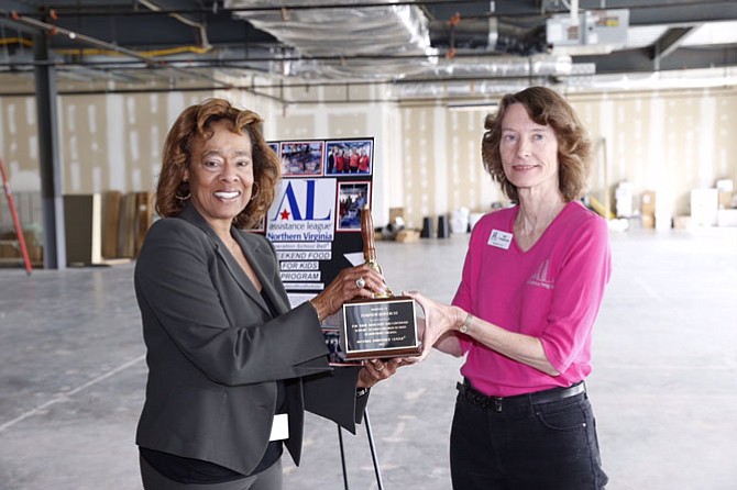 Pat Thompson, president of Assistance League of Northern Virginia, presents the award to Carolyn Moss, managing director, Mid-Atlantic, State & Local Affairs, Dominion Resources.
