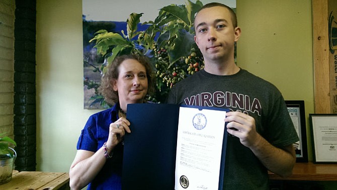 Joan Rizek and her son Calvin of the Fairfax area display the official proclamation from Gov. Terry McAuliffe (D) recognizing October as Dyslexia Awareness Month.